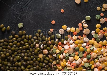 Placer lentils and green beans on a black table horizontal