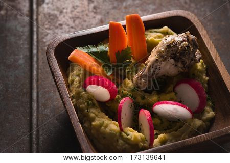 Salad of beans, chicken, carrots, radishes in a bowl horizontal