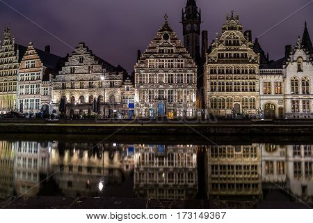 GHENT BELGIUM - 18TH FEB 2016: Ghent from the Graslei and Korenlei at night. The facades of buildings can be seen.