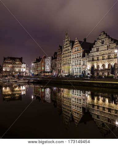GHENT BELGIUM - 18TH FEB 2016: Ghent from the Graslei and Korenlei at night. The facades of buildings can be seen.