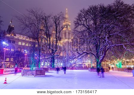 VIENNA AUSTRIA - 1ST FEB 2017: Wiener Eistraum (Vienna Ice World) at Rathausplatz in the winter. Rathaus (City Hall) can be seen in the distance.