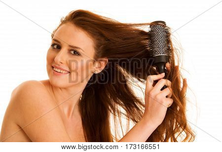 Beautiful Young Woman Combs Her Hair With A Brush Isolated Over White Background