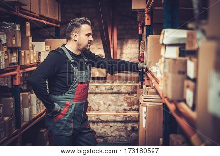 Storekeeper looking for exact goods on a warehouse