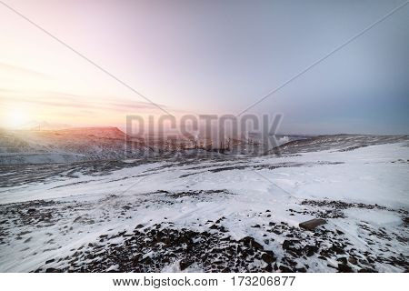 Steel works, smoking factory pipes. Winter landscape Arctic tundra