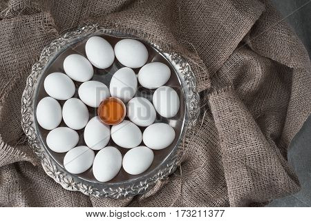 Ecological natural fresh eggs collected on a tray for cooking on the fabric.