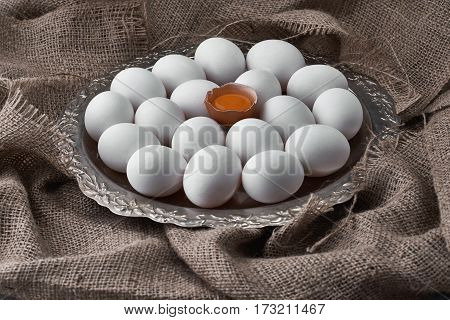 Ecological natural fresh eggs collected on a tray for cooking on the fabric.
