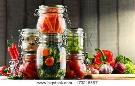 Jars With Marinated Food And Organic Raw Vegetables
