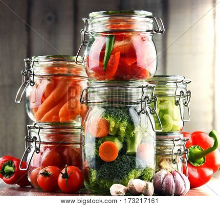 Jars With Marinated Food And Organic Raw Vegetables