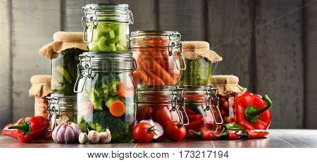 Jars With Marinated Food And Organic Raw Vegetables