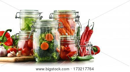 Jars With Marinated Food And Raw Vegetables Isolated On White