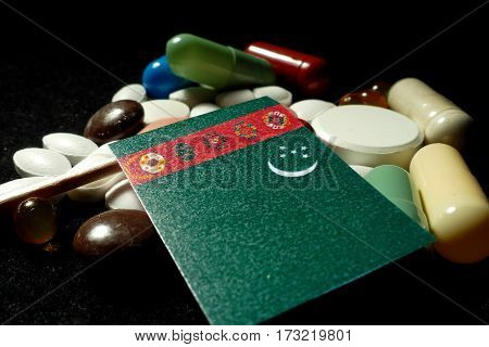 Turkmenistani Flag With Lot Of Medical Pills Isolated On Black Background