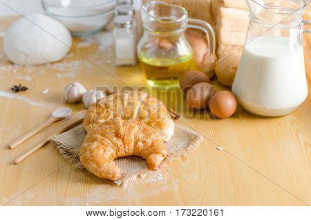 Close up shot of Croissant and bekery ingredients on wooden table