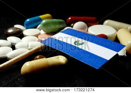 El Salvadoran Flag With Lot Of Medical Pills Isolated On Black Background