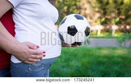 parents keep the soccer ball near the tummy