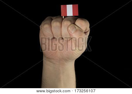 Man Hand Fist With Peruvian Flag Isolated On Black Background
