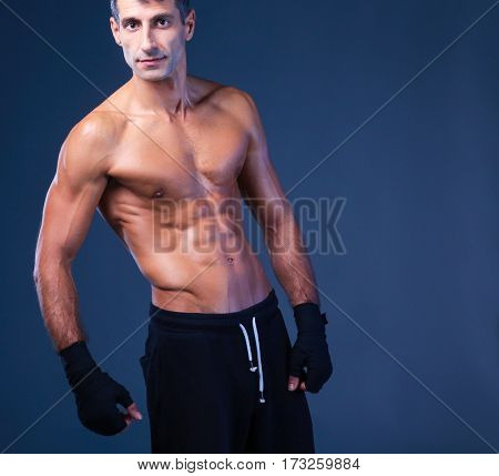 portrait of hand wrapping half nude boxer