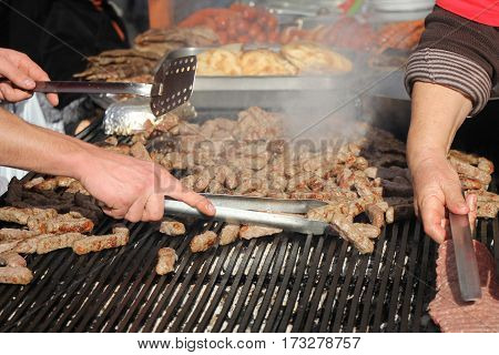 Grilling cevaps or kebabs on a grill at the street market