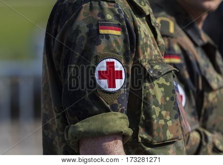 BERLIN / GERMANY - JUNE 3 2016: two german army soldiers with a red cross brassard