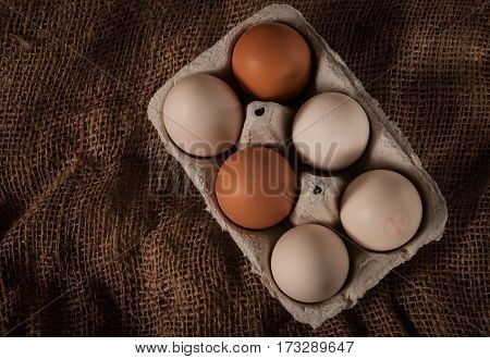Eggs cock in container on brown bag