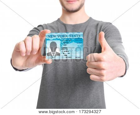 Man with driving license on white background