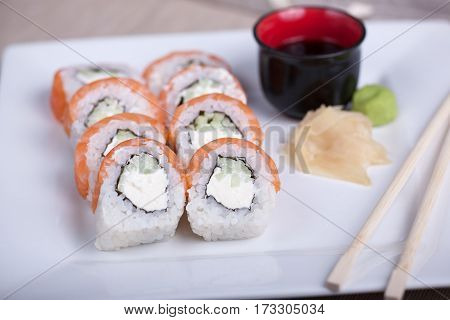 Philadelphia Sushi Roll With Red Fish On A White Plate