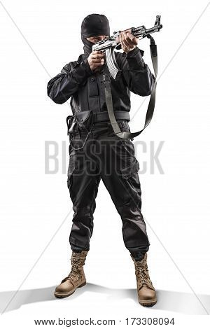 sodier in black military uniform aiming with machine gun isolated on white background