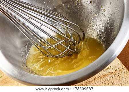 Whisking vigorously to disperse oil Making Mayonnaise oil food recipe