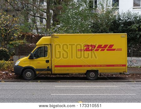 HAMBURG GERMANY - CIRCA NOVEMBER 2016: DHL Deutsche post van parked in a street of the city centre for delivery. DHL is one of the leading private mail companies in Europe.