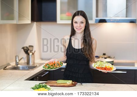 Young Woman Cooking in the kitchen. Healthy Food - Vegetable Salad. Diet. Dieting Concept.