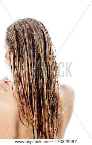 Photo of woman applying hair conditioner.