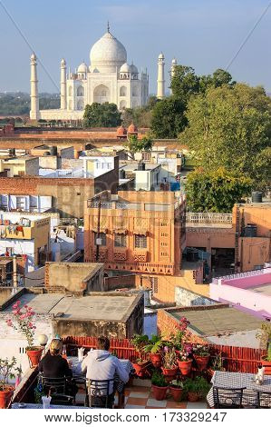 View of Taj Mahal from the rooftop restaurant in Taj Ganj neighborhood in Agra India. Taj Mahal was build in 1632 by Emperor Shah Jahan as a memorial for his second wife Mumtaz Mahal.