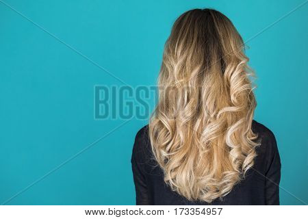 Female Long wavy blonde hair, rear view