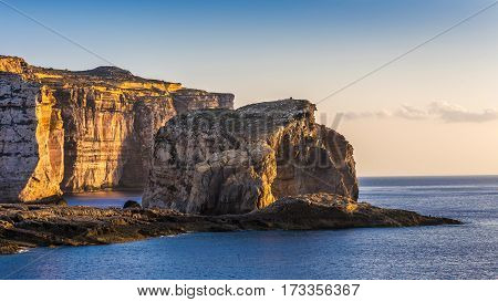 Gozo Malta - The famous Fungus rock on the island of Gozo at Dwejra bay at sunset