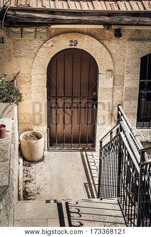 JERUSALEM ISRAEL - OCTOBER 3: The arched door with metal lattice of white stone house the historic neighborhood Yemin Moshe in Jerusalem Israel on October 3 2016