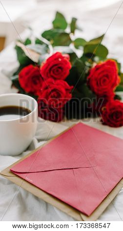 a bouquet of red roses coffee card with congratulations supply in bed