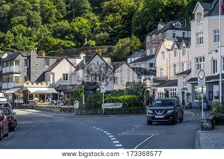 Lynmouth Devon England 13 July 2016: View of the street in the Riverside Road and Lynmouth street. Parked car. Against the backdrop of hills covered by forests. North Devon Coast.