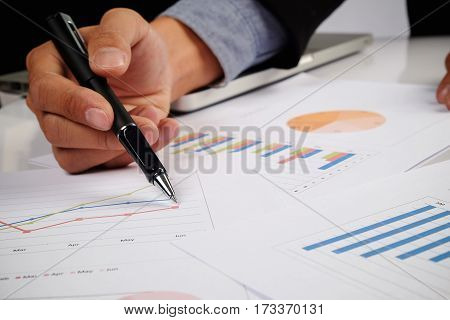 Business Man Hand Pointing At Business Document During Discussion At Meeting