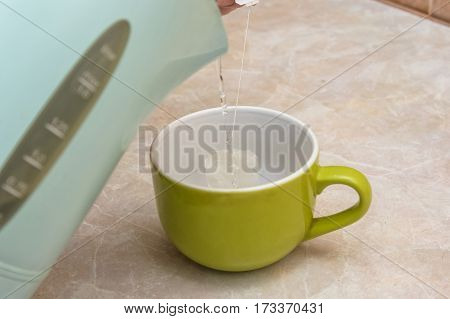 Teapot and cups are prepared for tea drinking at home