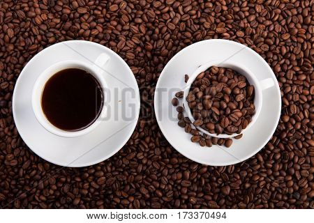 cup of coffee and cup with coffee beans at coffee beans