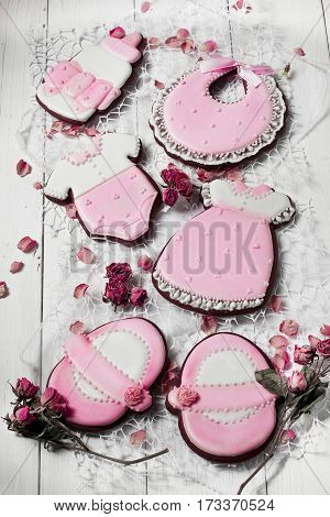 Cookies With Glaze In The Form Of Dress,baby Body,shoes,bottle Milk With Petals Of Dried Roses. On W