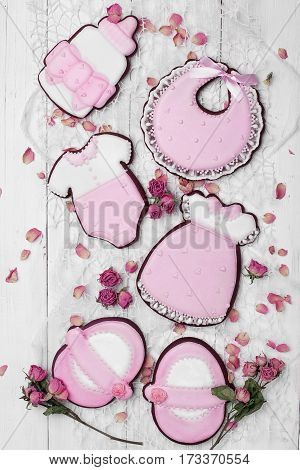 Cookies With Glaze In The Form Of Dress,baby Body,shoes,bottle Milk With Petals Of Dried Roses. On W