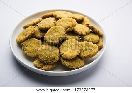 Tasty North Indian snack mathri or mathari served with pickle. Selective focus photograph.