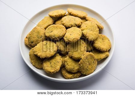 Tasty North Indian snack mathri or mathari served with pickle. Selective focus photograph.