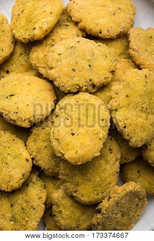 Tasty North Indian snack mathri or mathari served with pickle. Selective focus photograph.