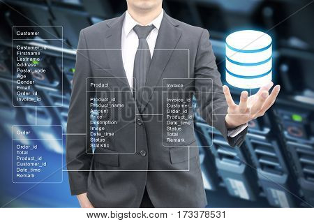 Professional Businessman Hold Database Table With Server Storage And Network In Datacenter Backgroun