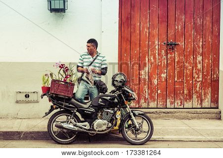 Popayan, Colombia - November, 17th, 2015 - flower sales man in white city popayan colombia south america