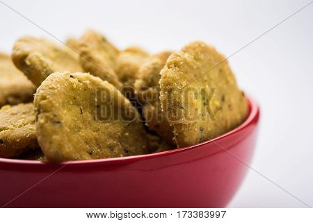 Tasty North Indian snack mathri or mathari served with pickle. Selective focus photograph.