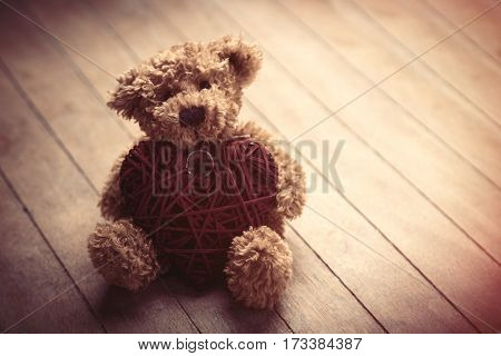 Cute Fluffy Teddy Bear With Heart Shaped Toy On The Wonderful Brown Wooden Background