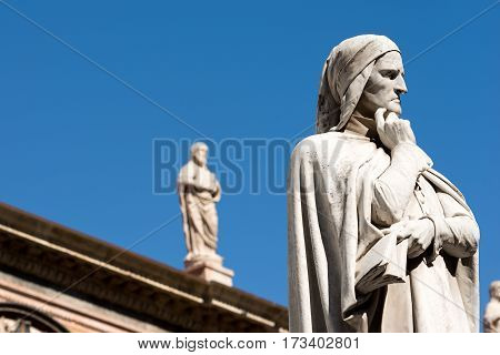 VERONA ITALY - SEPTEMBER 17 2016: Statue of Dante Alighieri (1265-1321) father of the Italian language in Piazza dei Signori in Verona (UNESCO world heritage site) Veneto Italy