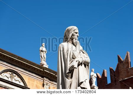 VERONA ITALY - SEPTEMBER 17 2016: Statue of Dante Alighieri (1265-1321) father of the Italian language in Piazza dei Signori in Verona (UNESCO world heritage site) Veneto Italy